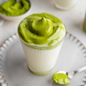 Beautifully presented dalgona matcha in a glass.