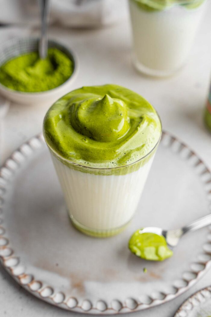 Beautifully presented dalgona matcha in a glass.