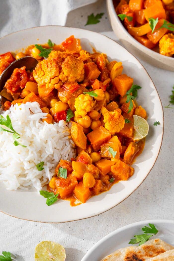 Roasted veegtable curry served with rice and cilantro.