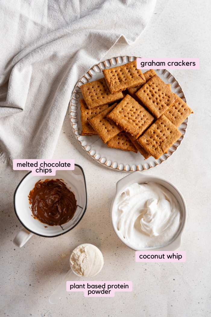 Ingredients for vegan frozen smores laid out and labeled on a light background.