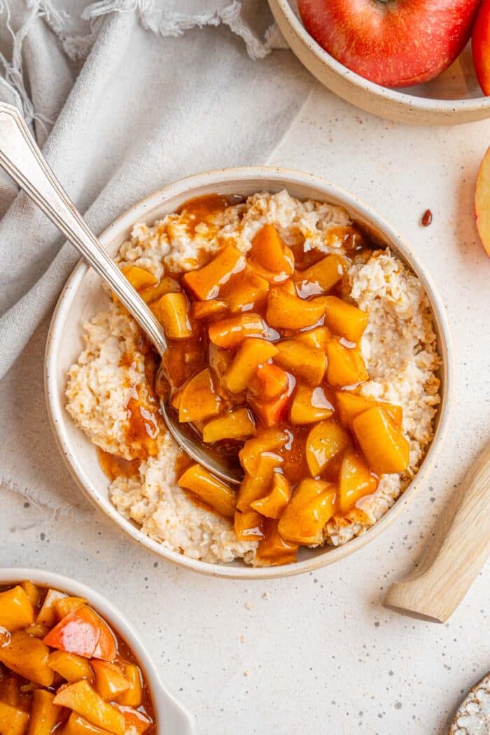 Healthy stewed apples served on top of oatmeal.