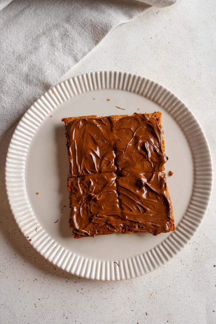 Melted chocolate spread on graham crackers.