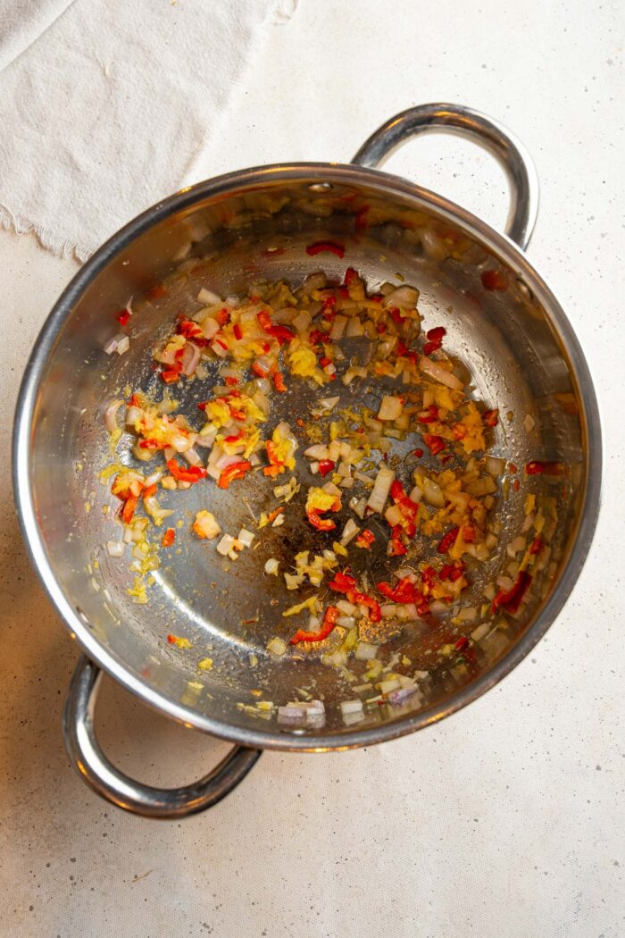 Aromatics in a steel pan sauteed with oil.