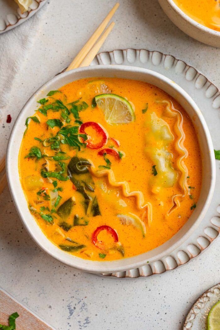 Top down view of easy red curry soup served over dumplings.