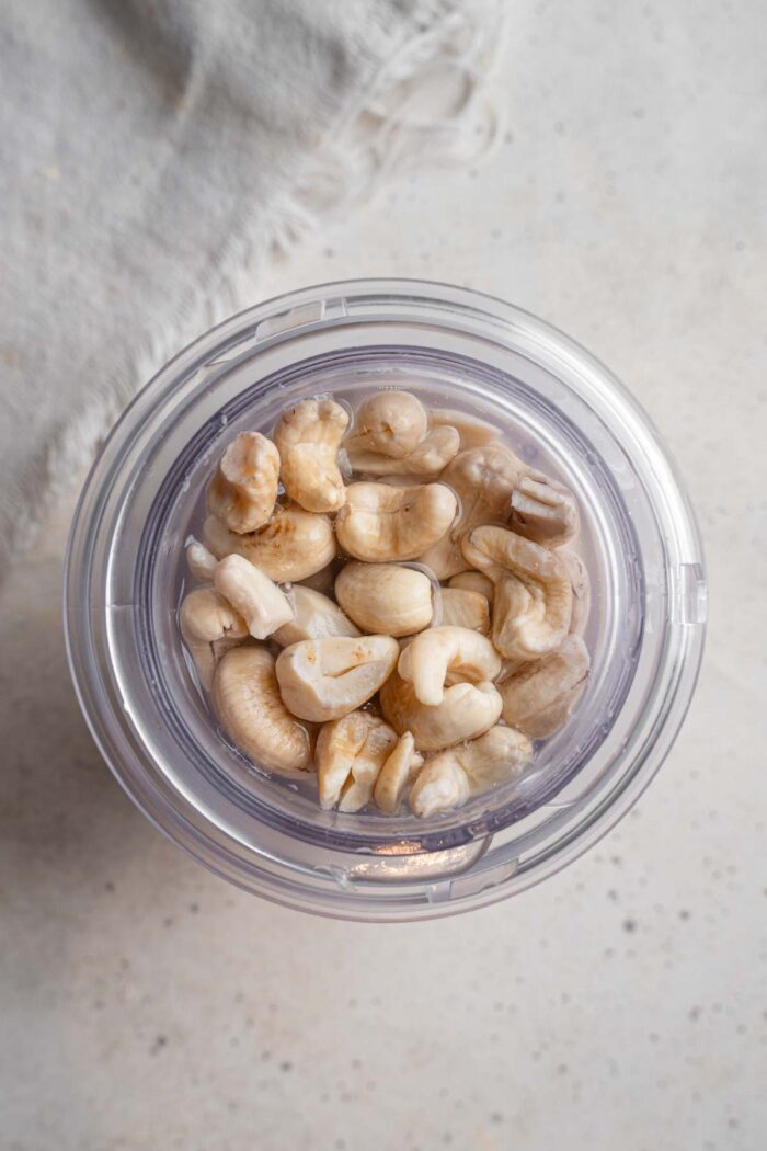 Soaked cashews in a blender cup.