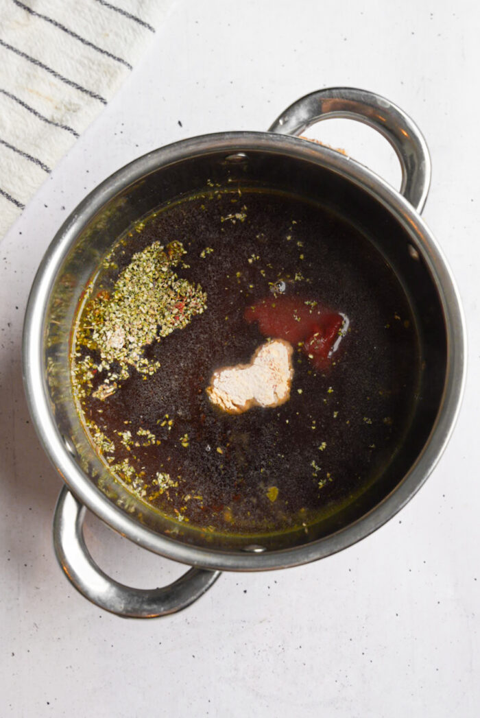 Vegan gravy ingredients together in a steel pot.