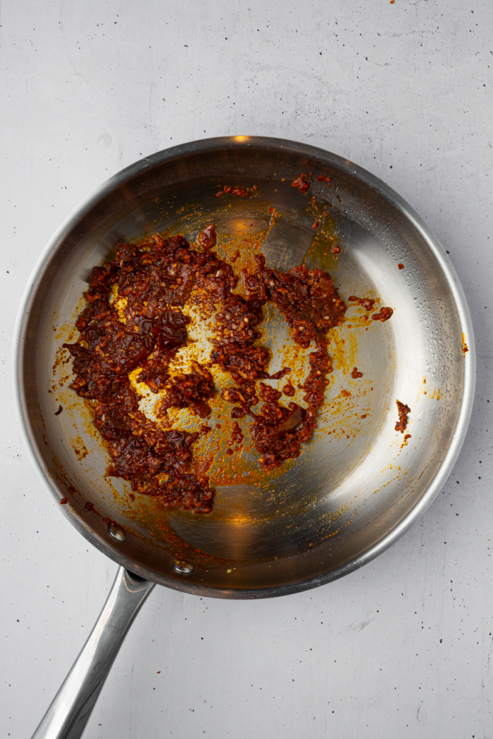 Garlic, chipotle peppers, seasonings and oil in a frying pan.