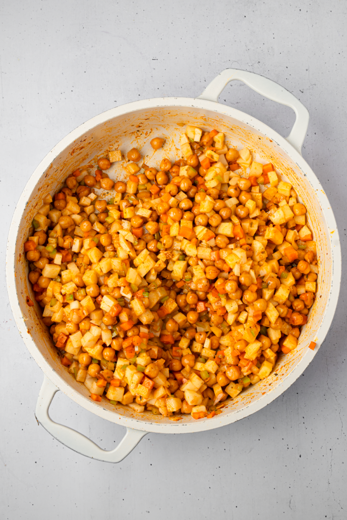 Chickpeas, carrots, celery and potatoes all together in a pan.