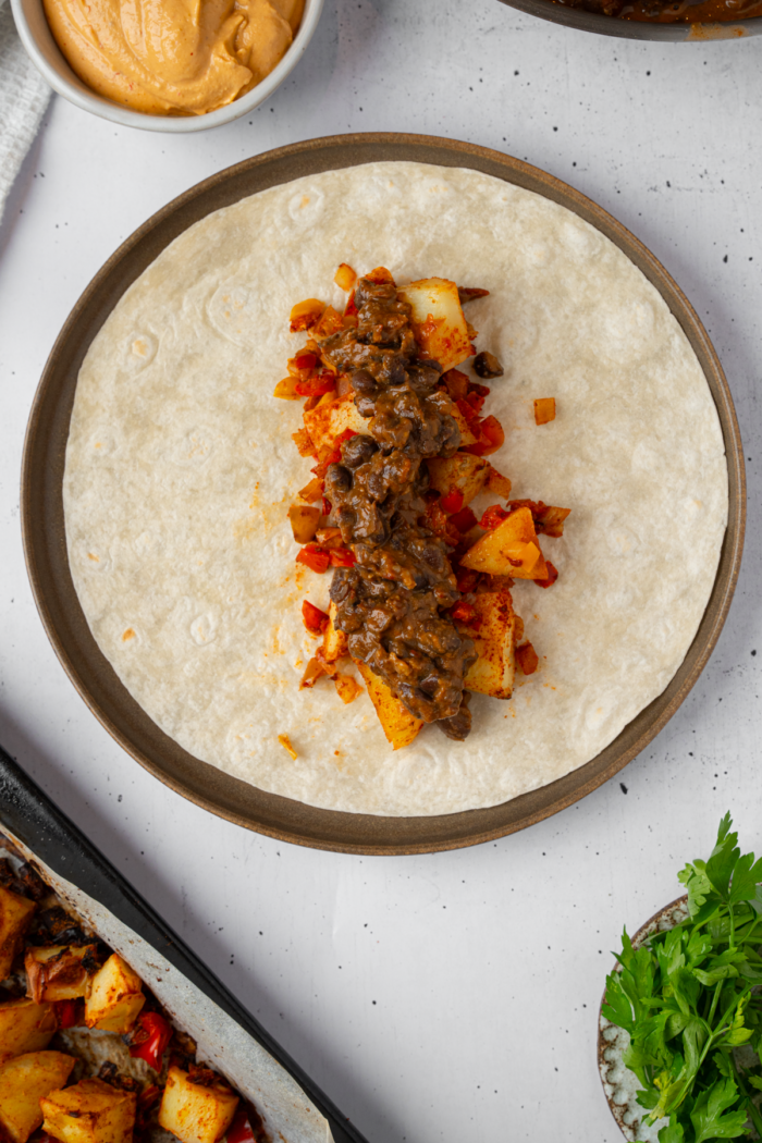 Black beans and potatoes in a tortilla wrap.