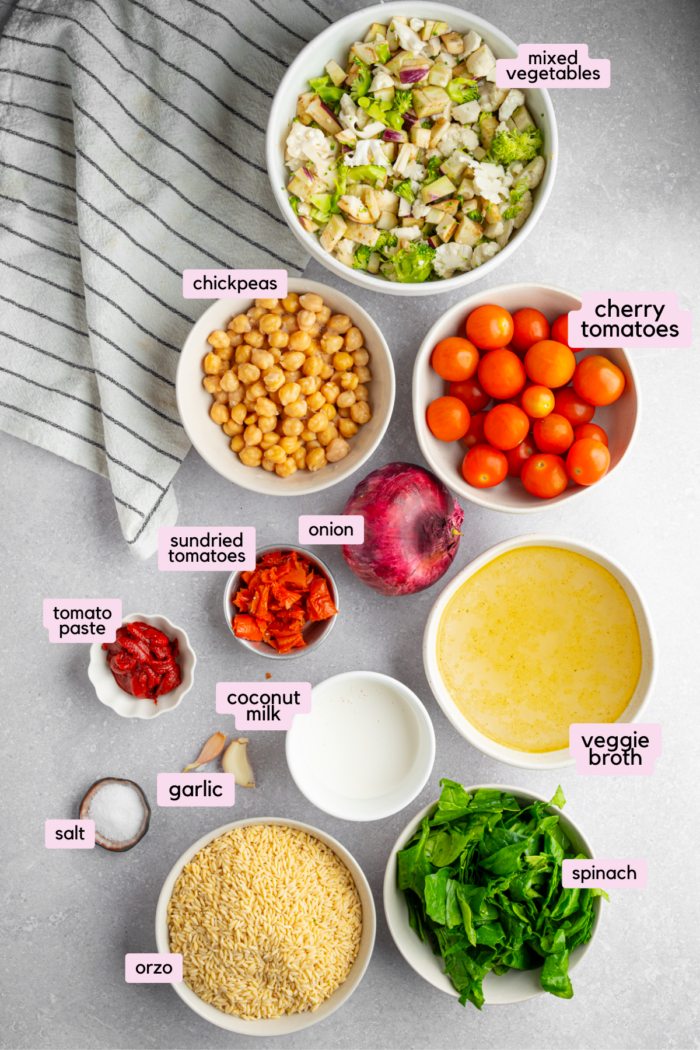 Every ingredient for the baked orzo with veggies, laid out and labeled.