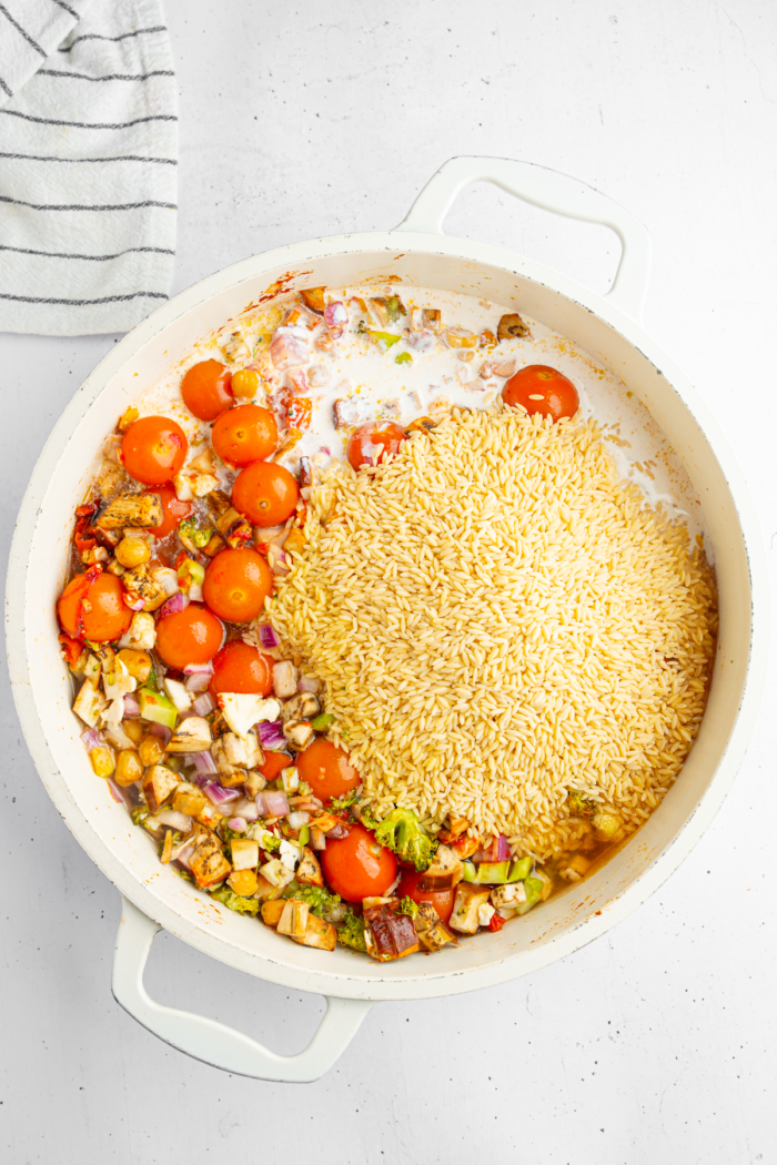 The dish after adding orzo, coconut milk, and remaining vegetable broth.