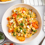 A serving of baked orzo with veggies.