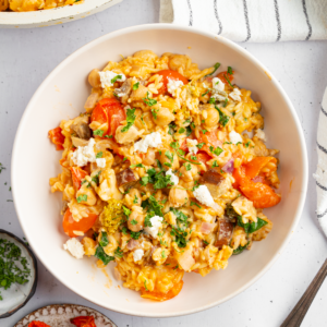 A serving of baked orzo with veggies.
