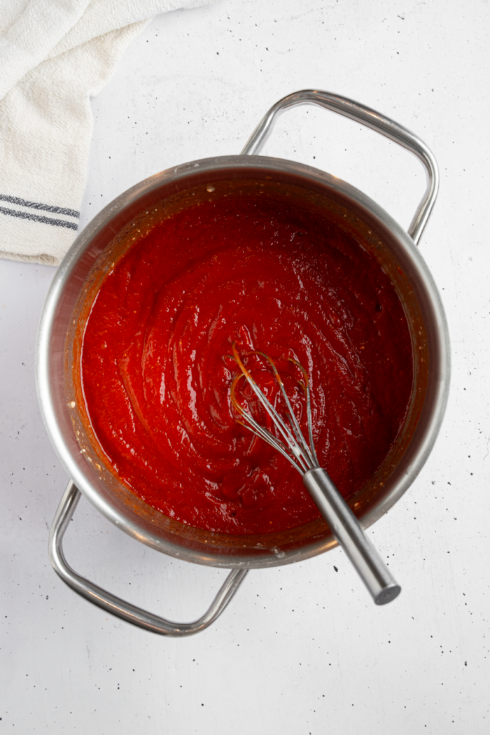 All of the homemade ketchup ingredients mixed together in a saucepan.