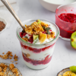 Assembled vegan yogurt parfait with fruit and granola on top.