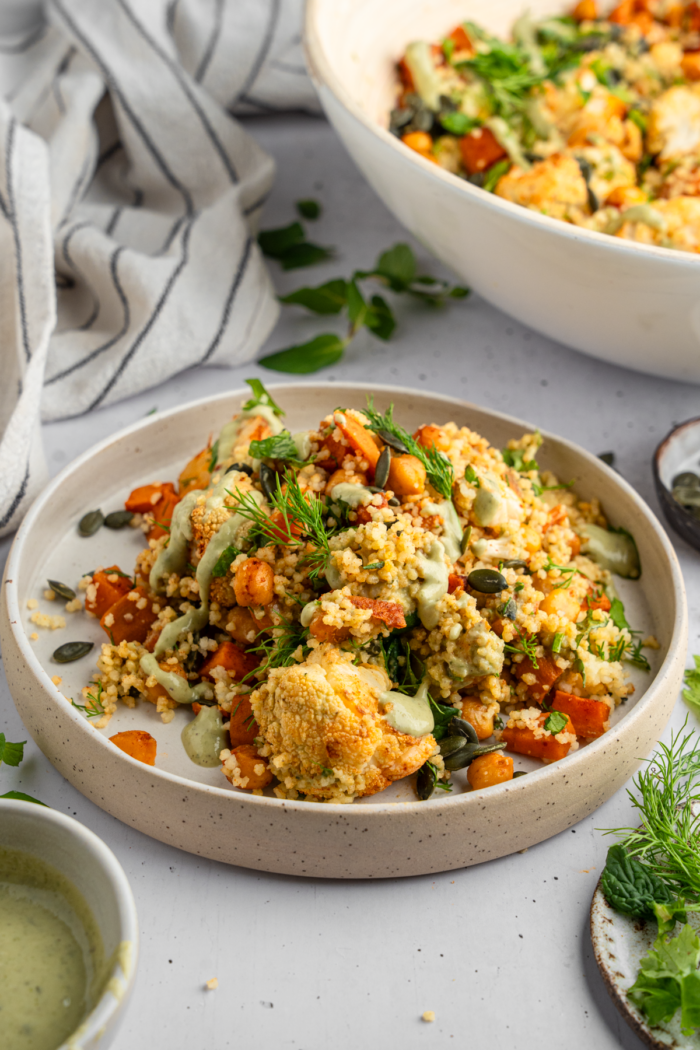 Cauliflower sweet potato couscous salad served in a shallow bowl.