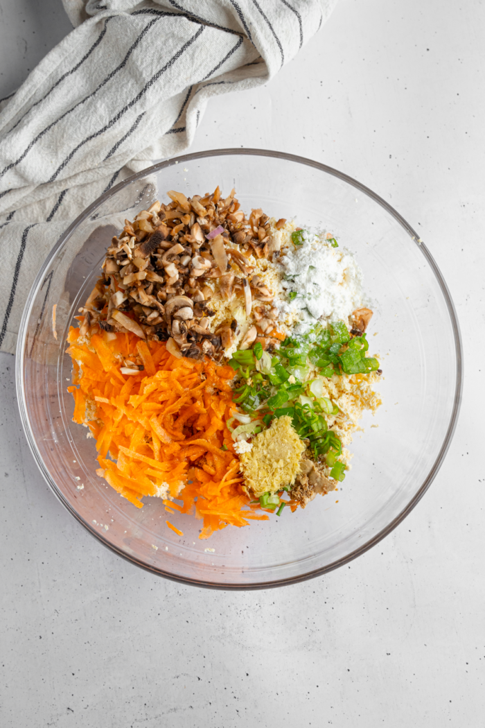 Filling ingredients, including vegetables, mushrooms, grated tofu, and flavorings.