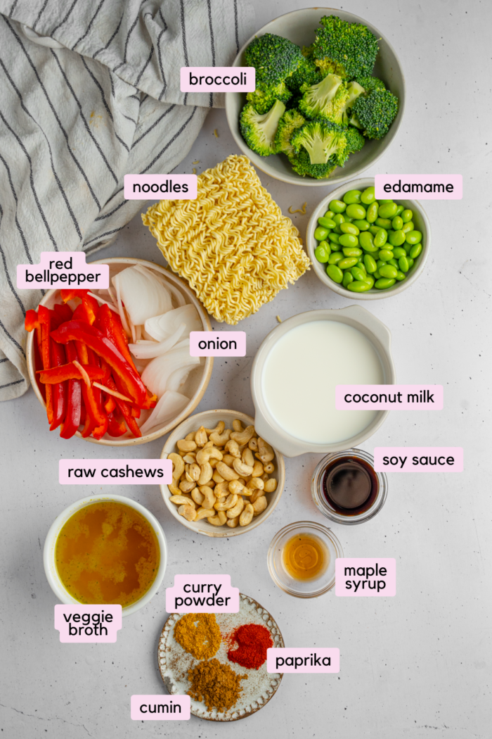 Ingredients for one pan curry noodles laid out and labeled on a light background.