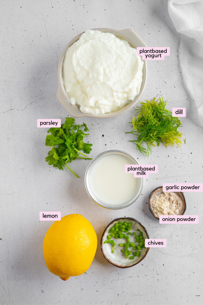 Ingredients for vegan ranch dressing laid out and labeled on a white background.
