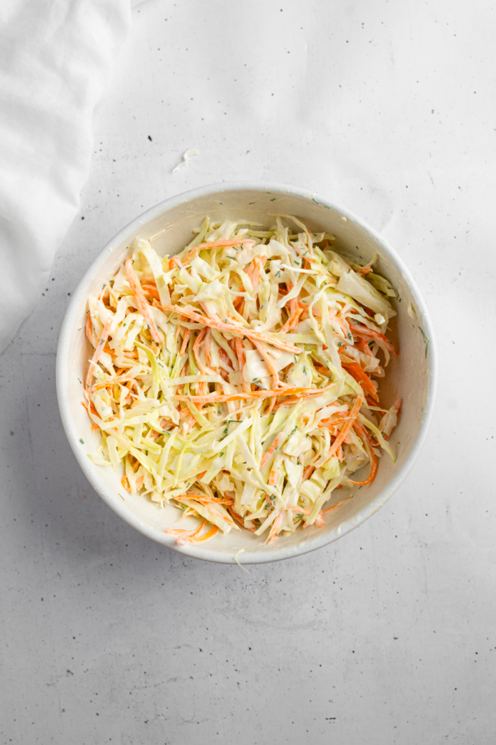 Cabbage and carrot mix added to the coleslaw dressing.