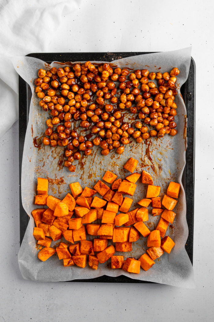 BBQ sauce added to the tray of roasted sweet potato and chickpeas.