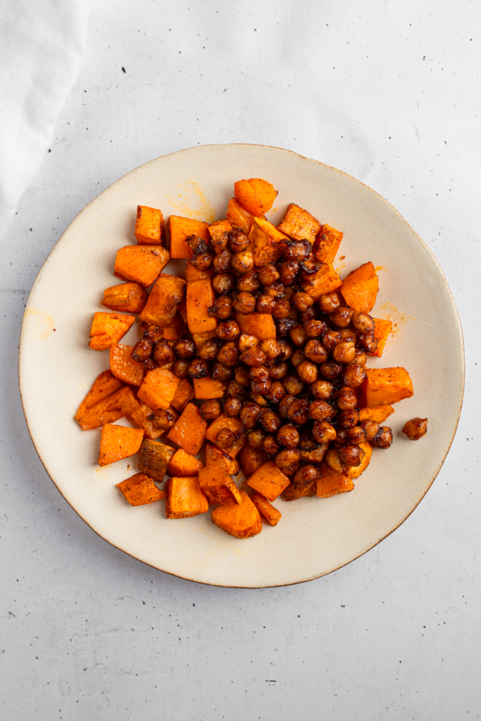 Roasted chickpeas added to the bowl with sweet potatoes.