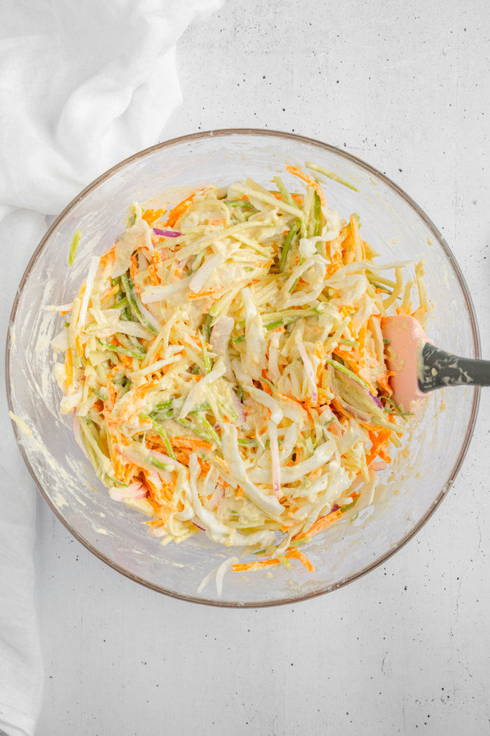 Grated vegetables mixed into the batter in the same bowl.