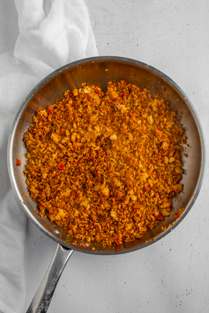 Shredded tofu cooked in a frying pan with spices and seasonings.