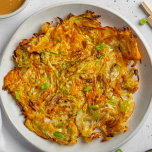 Closer shot of a vegetable pancake on a plate.
