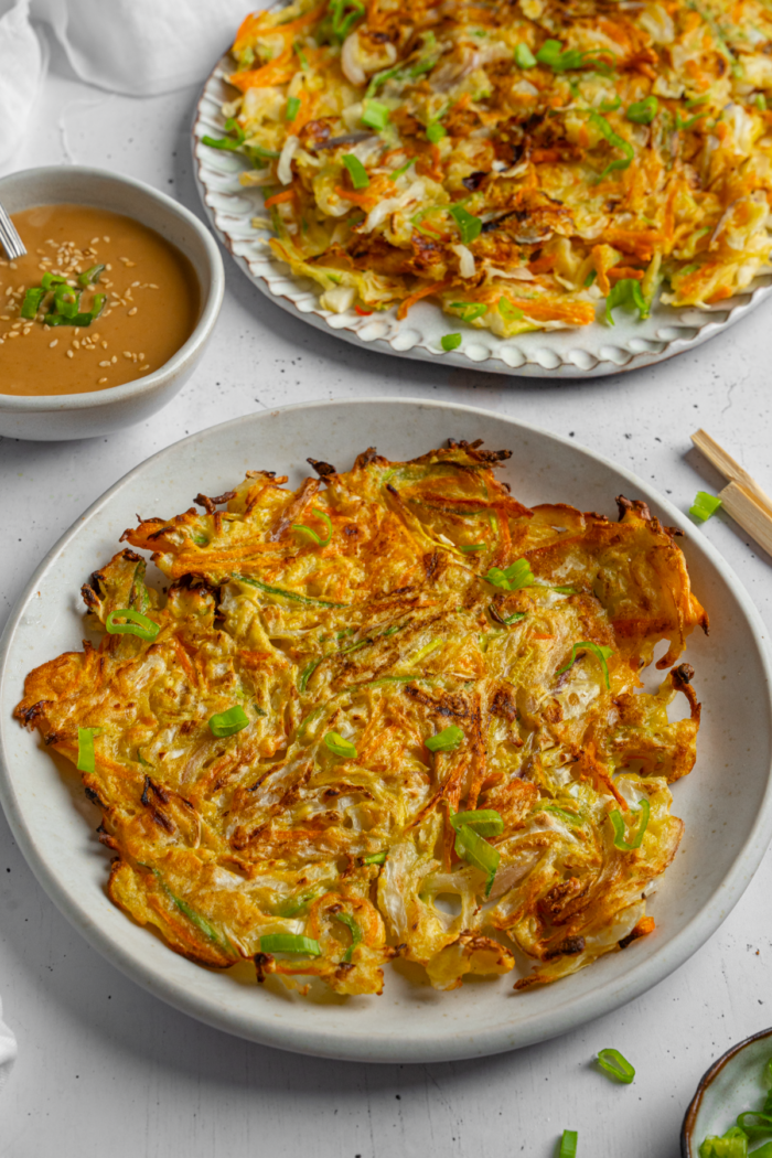 Vegetable pancake served on a white ceramic plate.