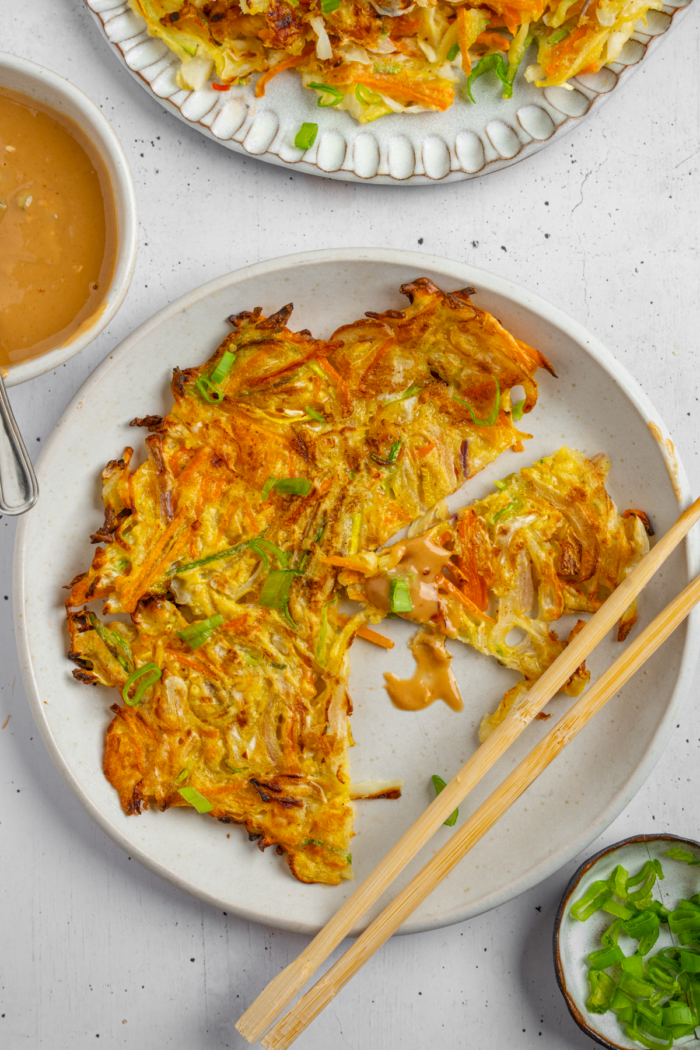 Vegetable pancake cut into bite sized pieces.