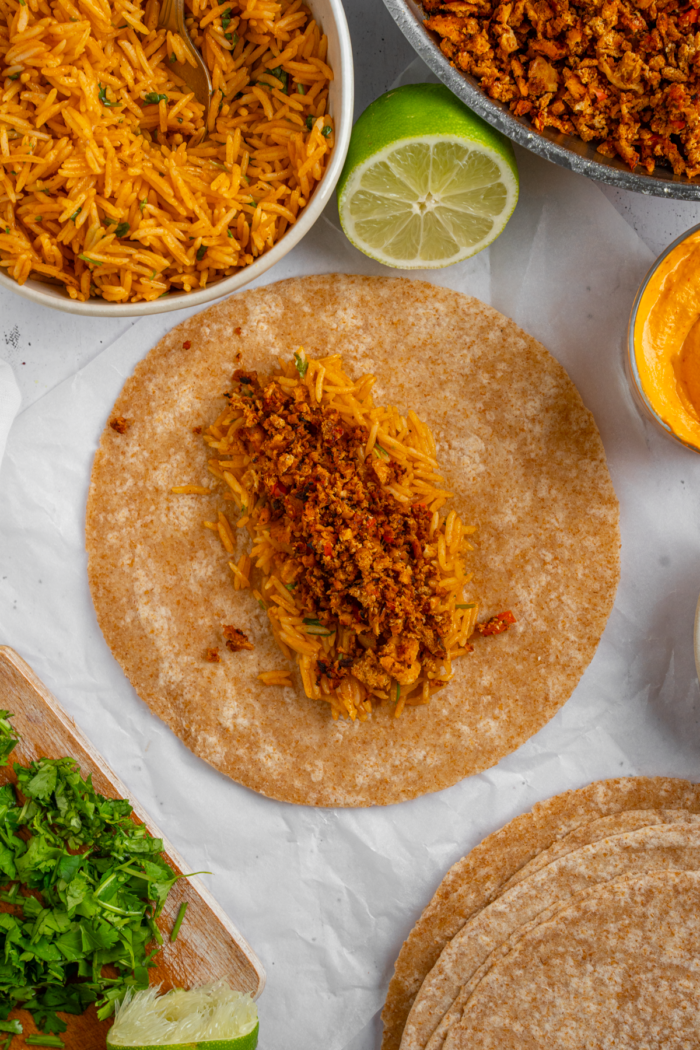 Burrito assembly, starting with spiced rice and tofu filling.