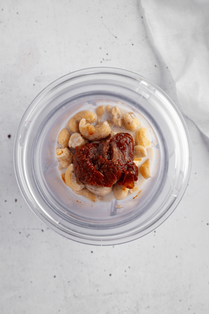 Vegan chipotle mayo ingredients in a high-speed blender.