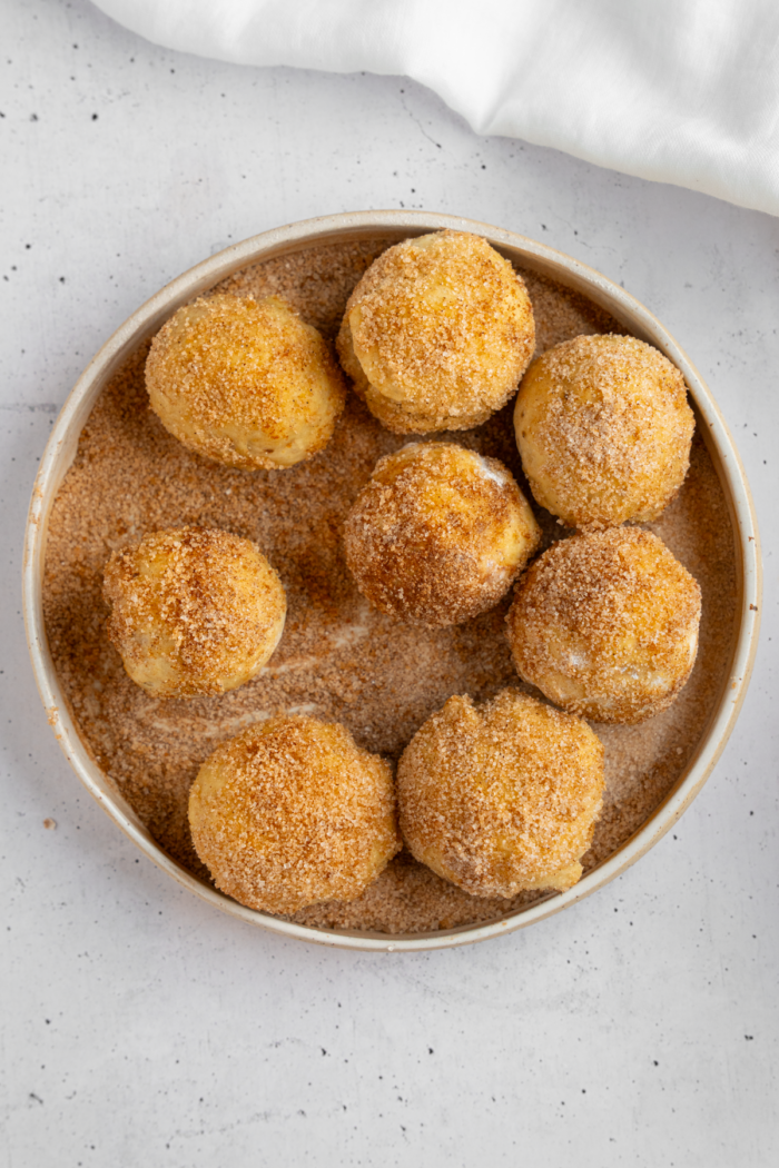 Banana donut holes dipped and coated in cinnamon sugar.
