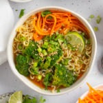 Spring noodle soup served in a large ramen bowl.