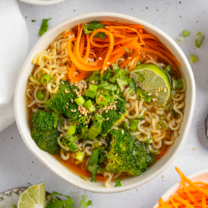 Spring noodle soup served in a large ramen bowl.