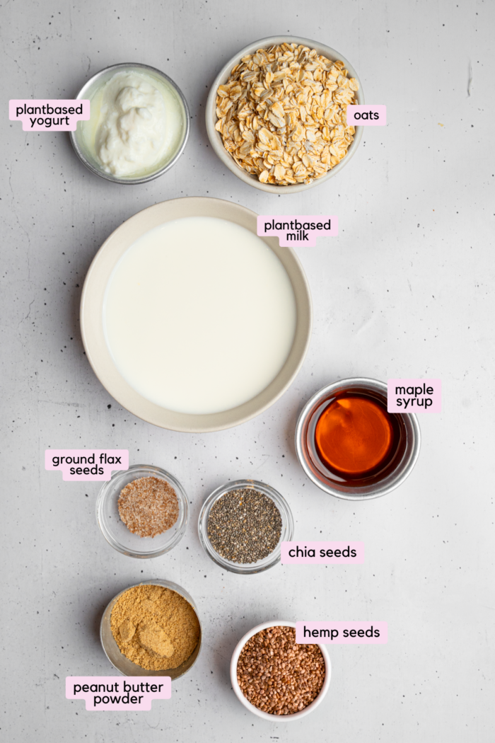 Ingredients for high protein overnight oats laid out and labeled on a light background.