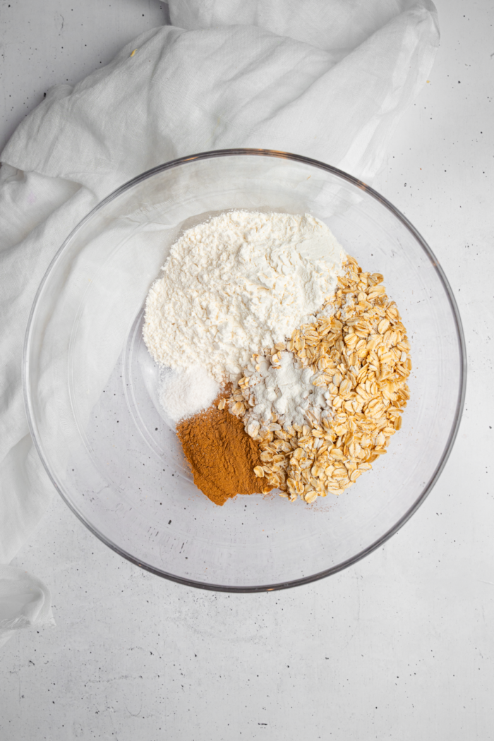 Dry ingredients for carrot cake baked oatmeal in a mixing bowl.