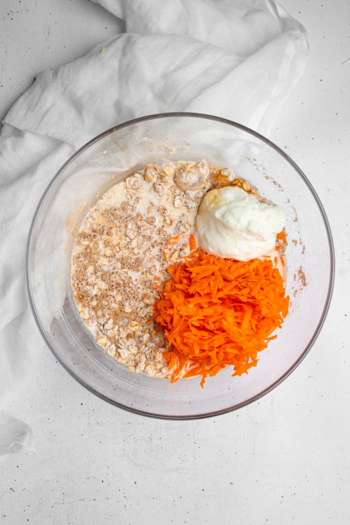 Wet ingredients added to the dry mixture for carrot cake baked oatmeal.