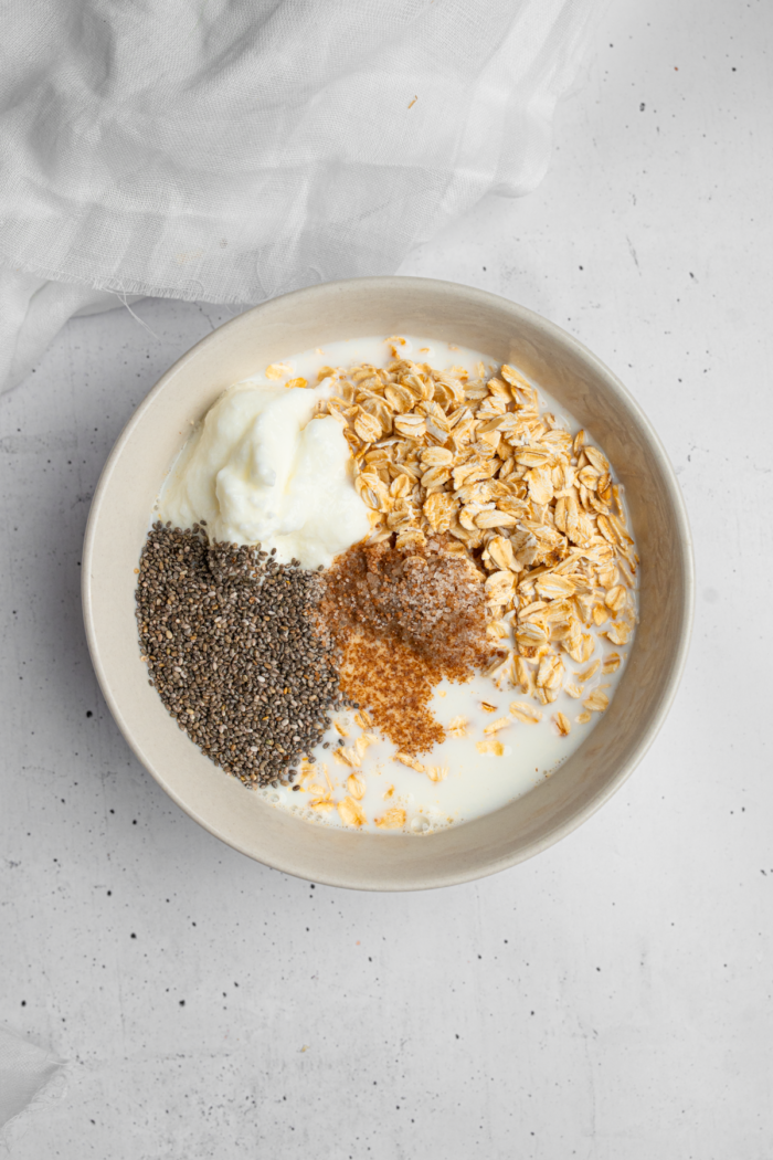 Ingredients for the high protein overnight oats together in a bowl.