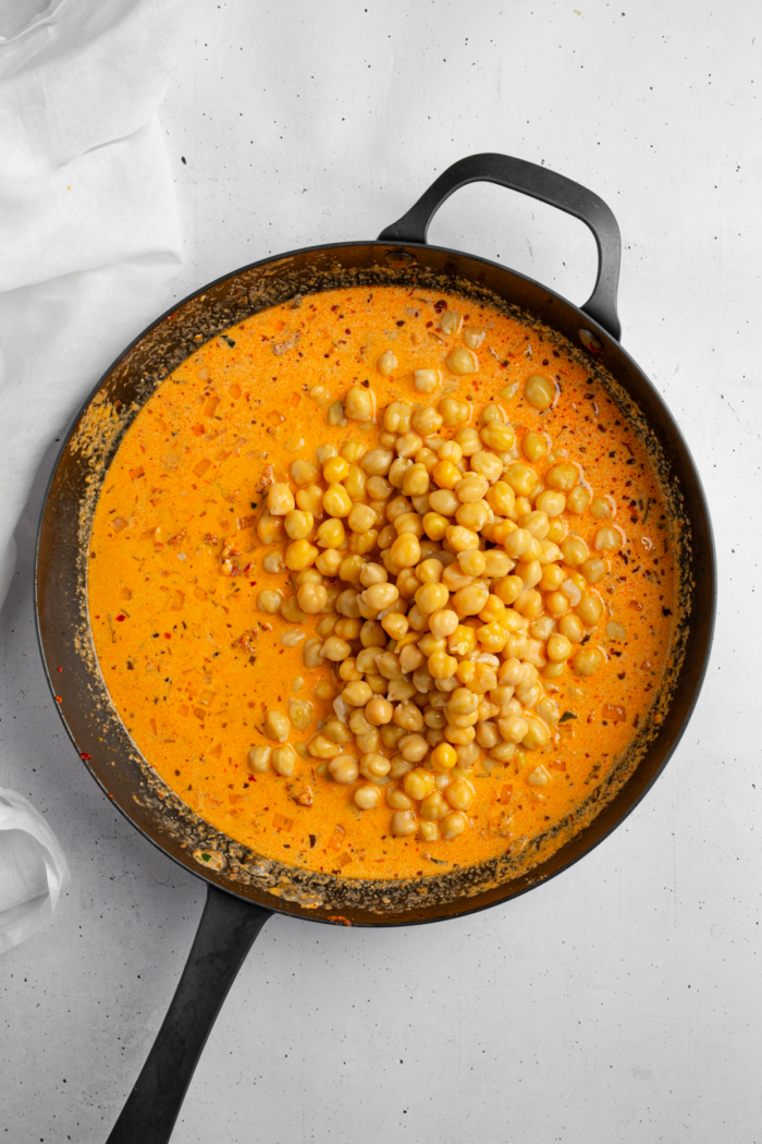 Drained chickpeas are added to the creamy marry me sauce.