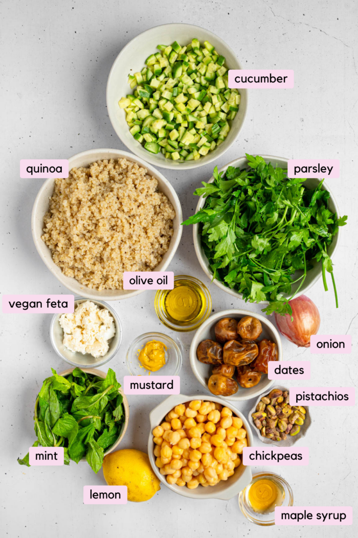 Ingredients for the vegan couscous salad laid out and labeled on a light background.