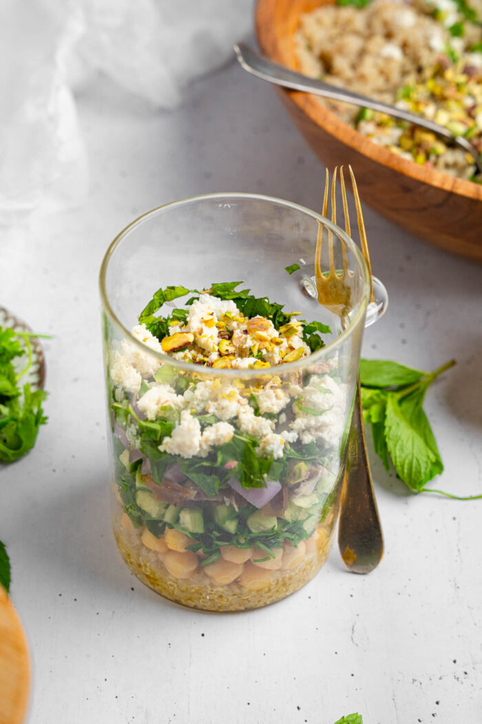 Top view of a meal prep jar with Vegan couscous salad with feta and mint.