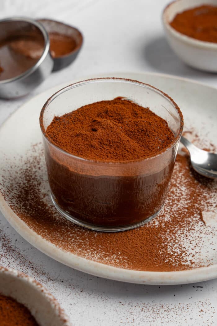 Rice chocolate pudding dusted with cocoa and served on a plate.