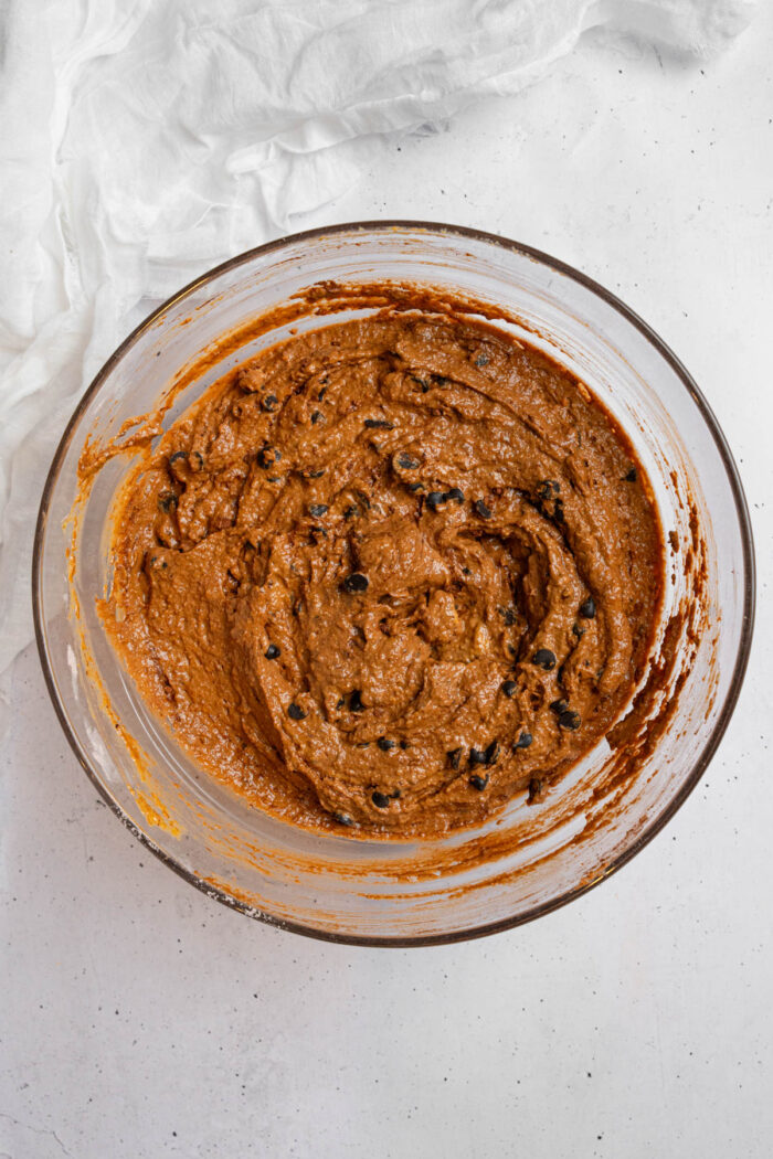 Full hidden veggie muffins batter with chocolate chips folded in.