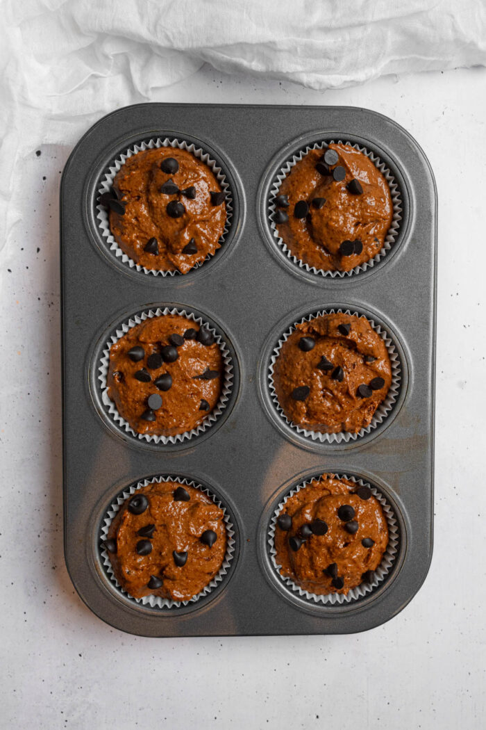 Hidden veggie muffin batter split into muffin tray.