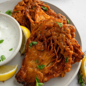 Vegan fried chicken served with vegan ranch and fresh herbs.