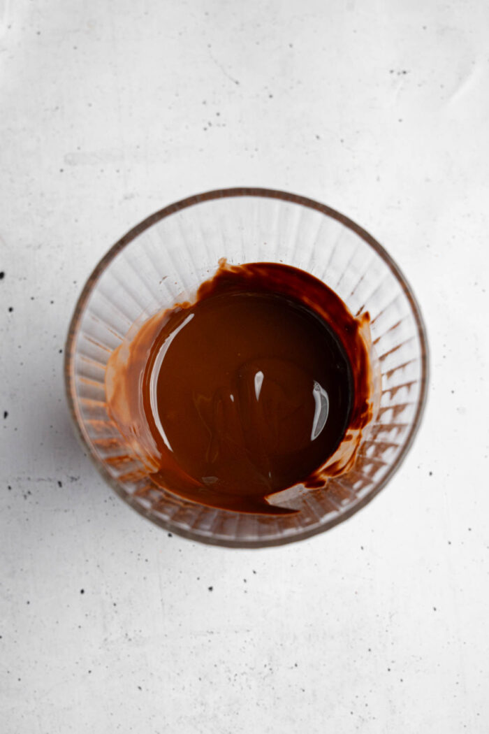 Melted chocolate in a glass, photographed from the top.