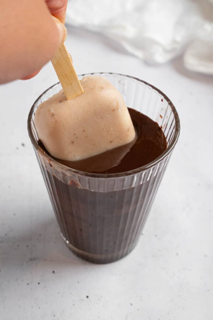 A vegan healthy homemade ice cream bar dipped in chocolate.