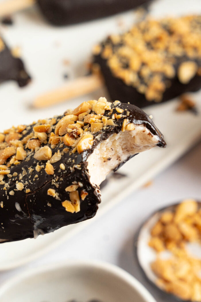 Healthy homemade vegan Magnum with a bite taken out of the bar.